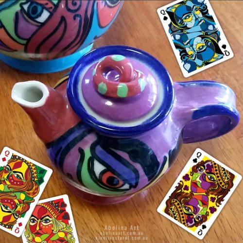 Teapot and playing cards on table by Abolina Art