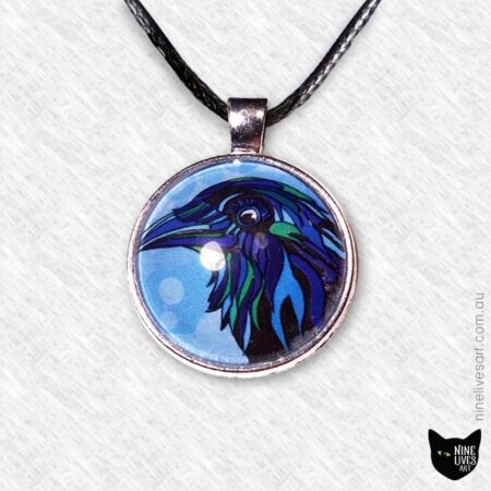 Small blue raven pendant strung on cord