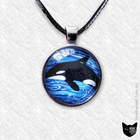 Orca swimming in blue waves 25mm art pendant strung on cord