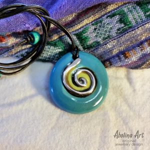 Turquoise stoneware pendant with silver spiral strung on leather cord