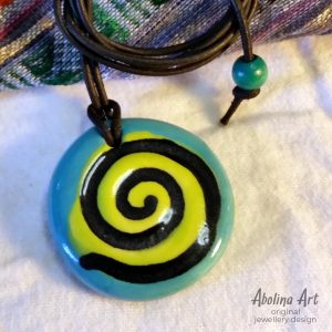 Turquoise spiral pendant strung on leather cord