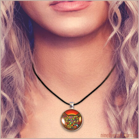 Model wearing bright and colourful cat pendant