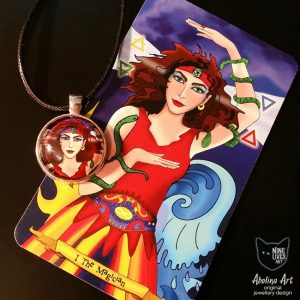 art pendant featuring female archetype Magician from Nine Lives Tarot placed over (detail) original artwork