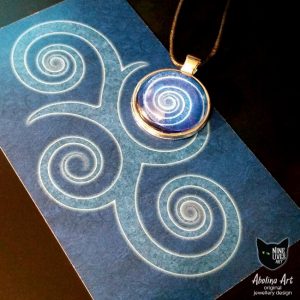 Blue spiral 25mm pendant displayed with back of Nine Lives Tarot card