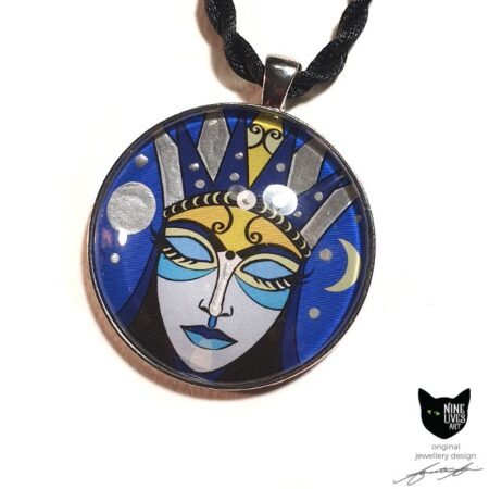 Art pendant featuring moon goddess with closed eyes on blue background, sealed under glass dome with silver coloured bezel and pendant cord