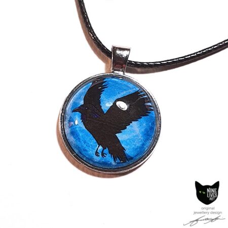 Black raven flying on a turquoise blue sky background - 25mm silver coloured pendant setting
