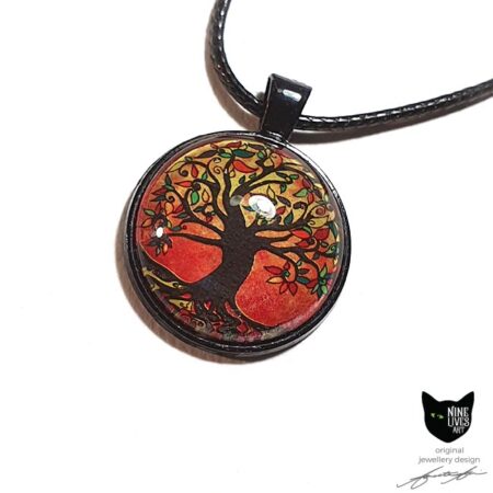 Autumn colours define this original tree of life art pendant set in a black bezel and sealed under glass cabochon