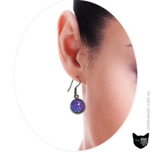 Model wearing purple paisley earrings