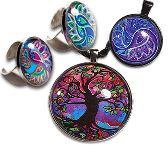 Paisley flower rings and pendant displayed with larger Tree of Life pendant in vibrant purple hues
