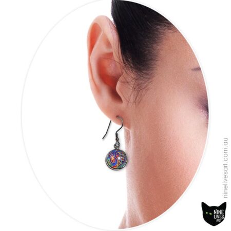 Model wearing blue paisley design earring
