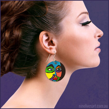Hand-painted earring featuring bold and colourful face