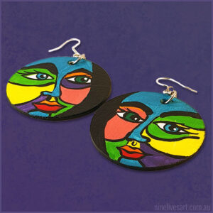 Hand-painted earrings depicting bold and colourful faces