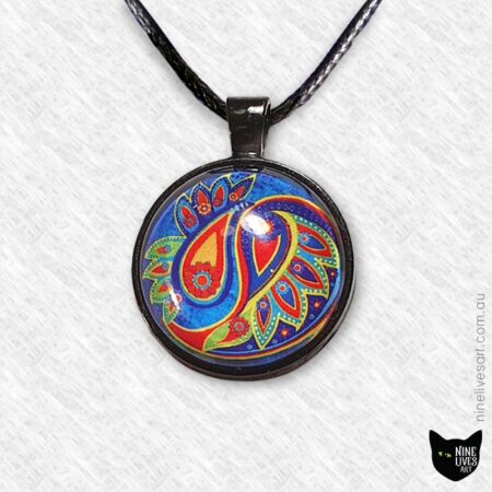 Paisley pendant in vibrant blue and orange set in 25mm cabochon and strung on cord