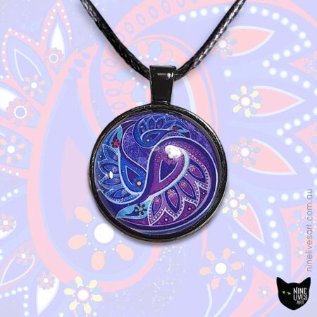 Paisley pendant in purple hues set in 25mm cabochon and strung on cord