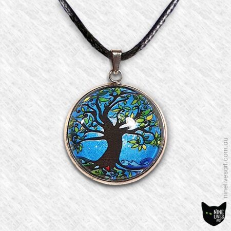 Tree of Life art pendant incorporating bright blue tones, sealed under cabochon, striking and original jewellery