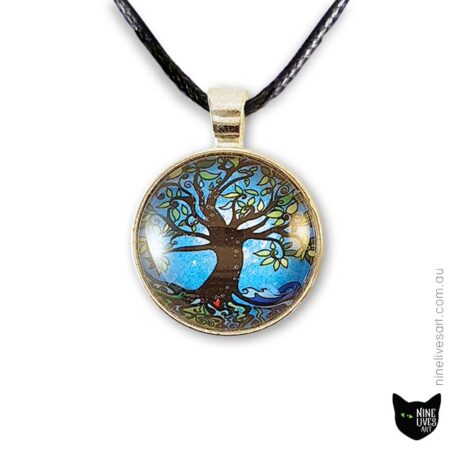 Tree of Life art pendant incorporating bright blue tones, sealed under cabochon, striking and original jewellery