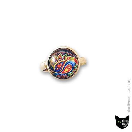 12mm cabochon ring with paisley design in bright colours on blue background