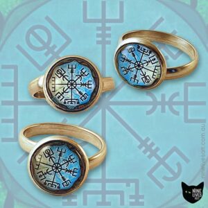 3 cabochon rings with blue viking compass designs, featured on faint rendition of artwork
