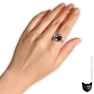 Model wearing 12mm cabochon ring with whale artwork