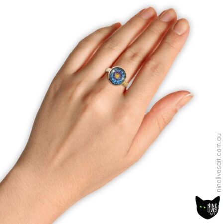 Model wearing 12mm zodiac ring with sun on blue background