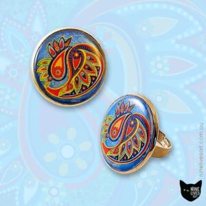 25mm Paisley design ring in bright colours on textured blue background