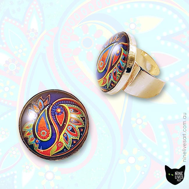 25mm handmade rings with paisley design sealed with glass cabochons and silver coloured base
