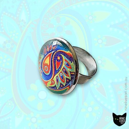 25mm cabochon ring in original paisley design featuring bright colours on jade background