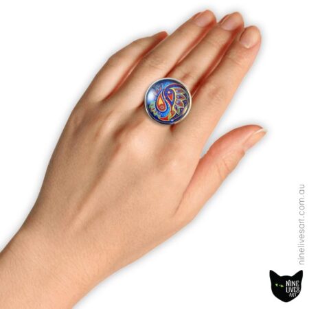 Model wearing 25mm cabochon ring with blue paisley design