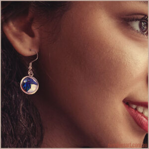 Model wearing blue raven head earring