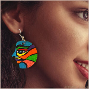Model wearing 40mm handpainted earring with face design