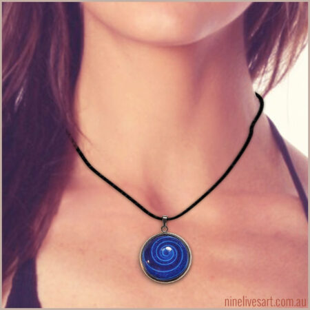 Model wearing gorgeous blue spiral pendant