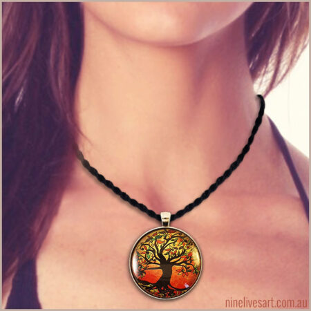 Model wearing Tree of Life pendant in warm autumn colours