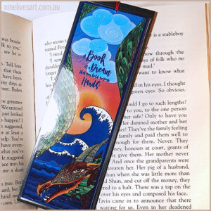 Art bookmark featuring a dragon framing ocean waves and blue skies