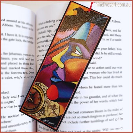 Bookmark Hero's Journey, male face in profile painted in bright colours with a raven, compass and map in background.