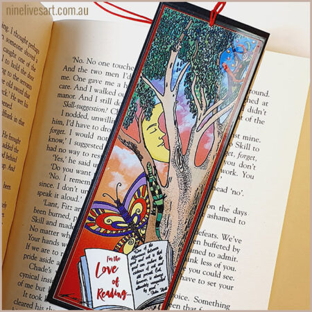 Art bookmark featuring a jester juggling in a tree with an open book, the moon and a butterfly below.